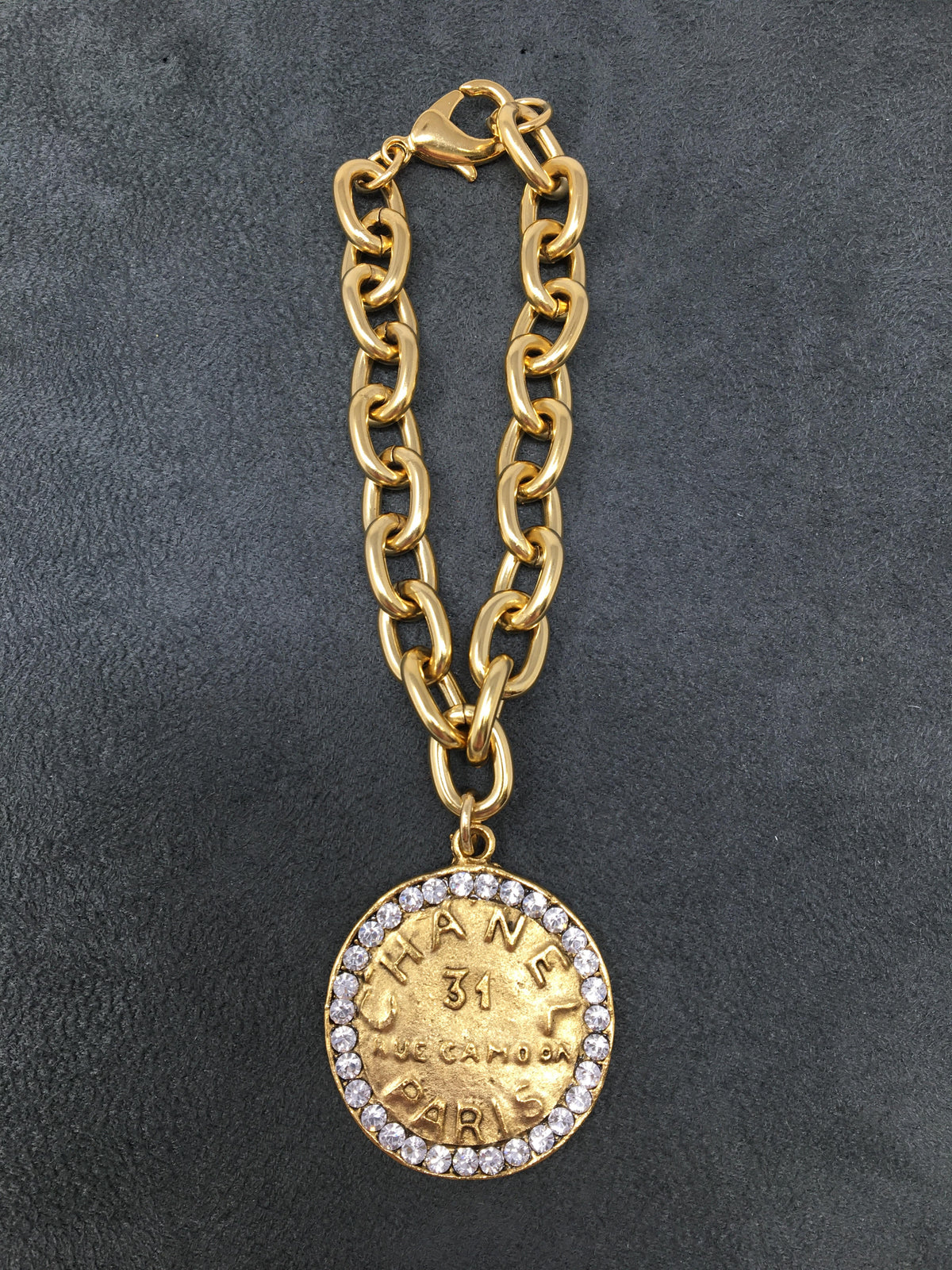 4-inch gold link bracelet featuring a Chanel-style coin pendant with rhinestones.