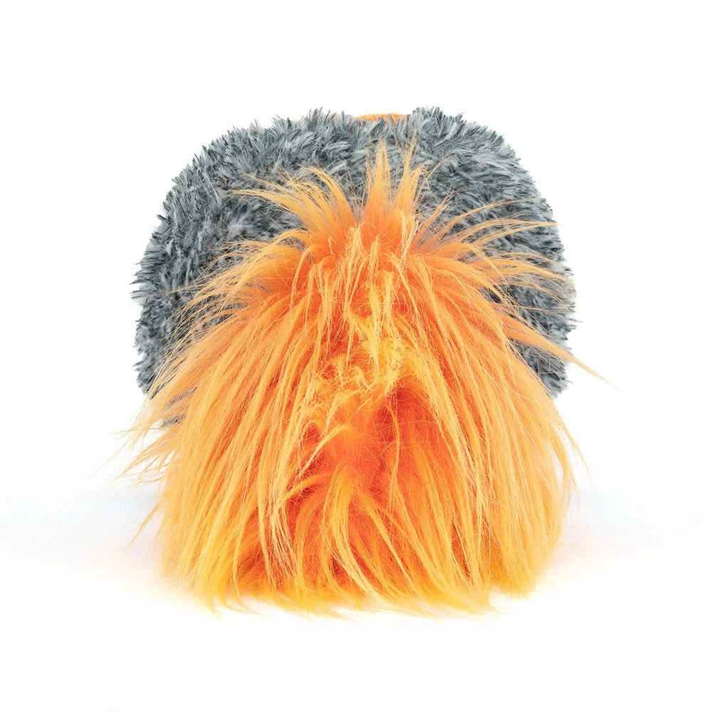 Back view of a plush comet toy with a grey textured body and a long, bright orange fuzzy tail.