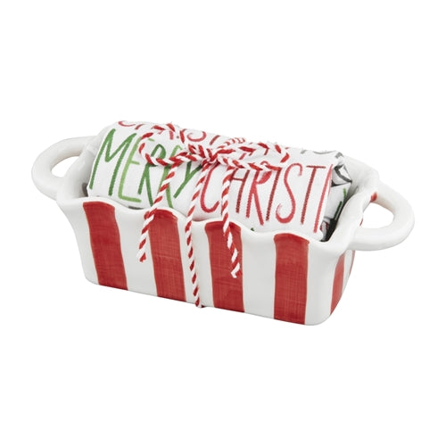 White ceramic mini Christmas loaf set with festive red trim on a matching towel.