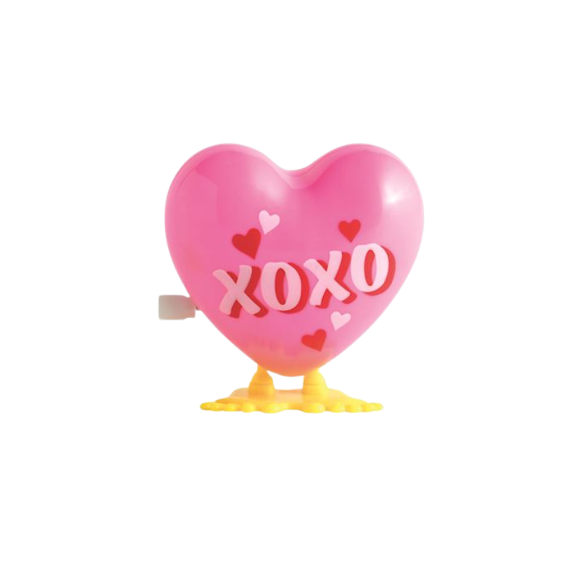 Pink wind-up hopping heart toy with 'XOXO' text and yellow feet.