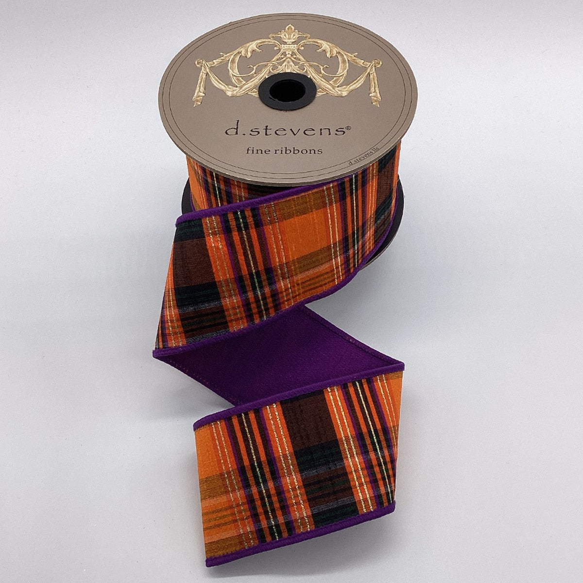 2.5 inch Salem plaid ribbon in orange, black, and purple with gold lurex on a d.stevens spool.