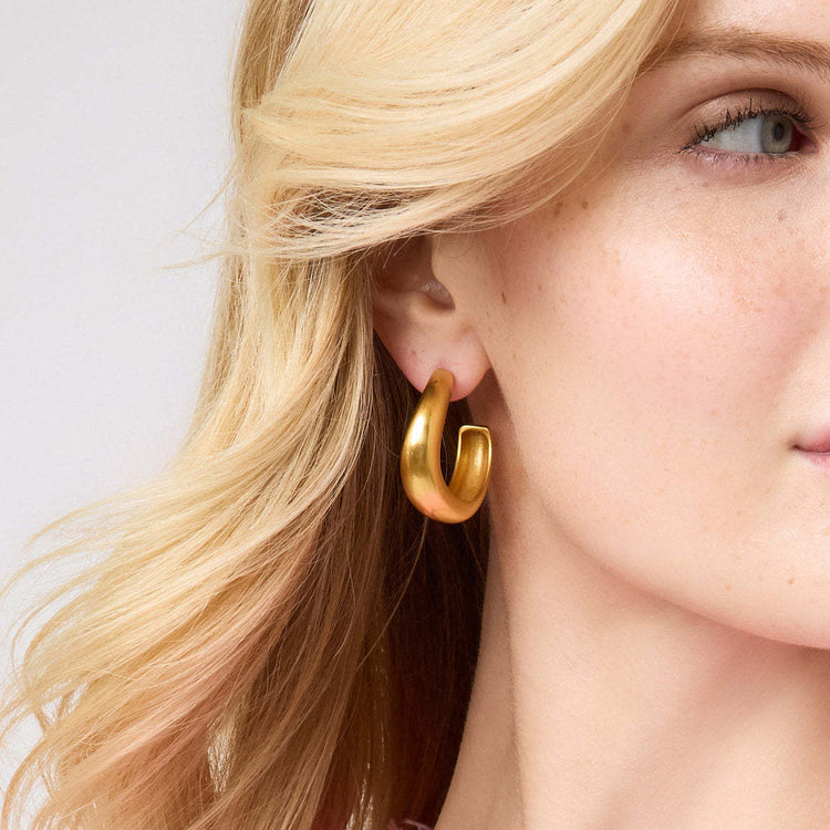 Curvaceous golden Wave Hoop earrings with open interiors in small size