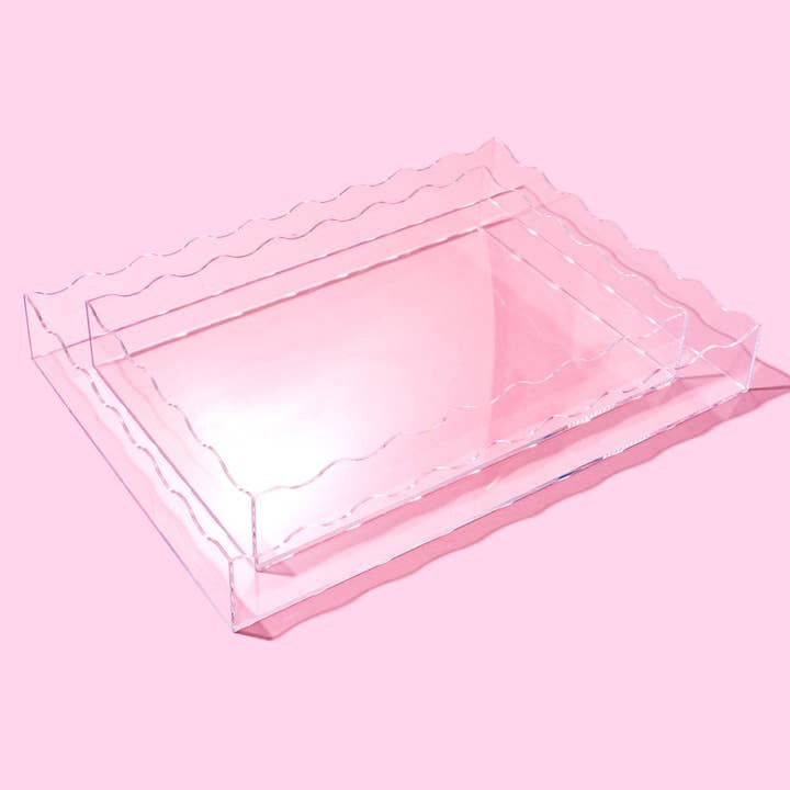 Large clear acrylic rectangular tray with wavy edges measuring 13 by 18 inches.