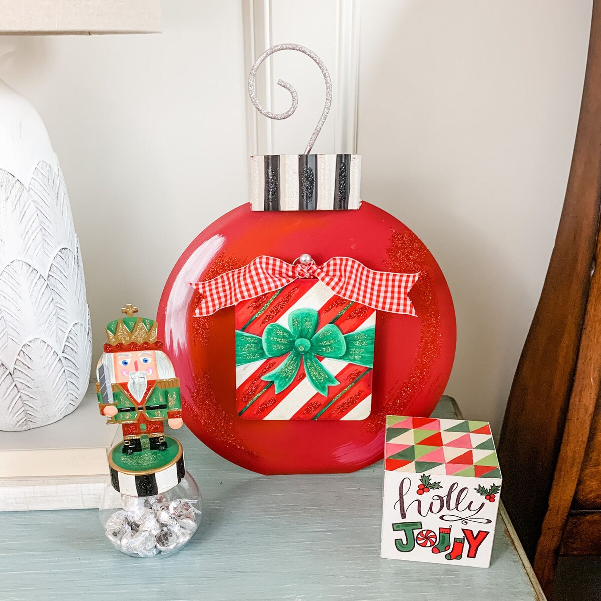 Ornament display board with a natural wood finish, designed to stake, hang, or use as an easel.