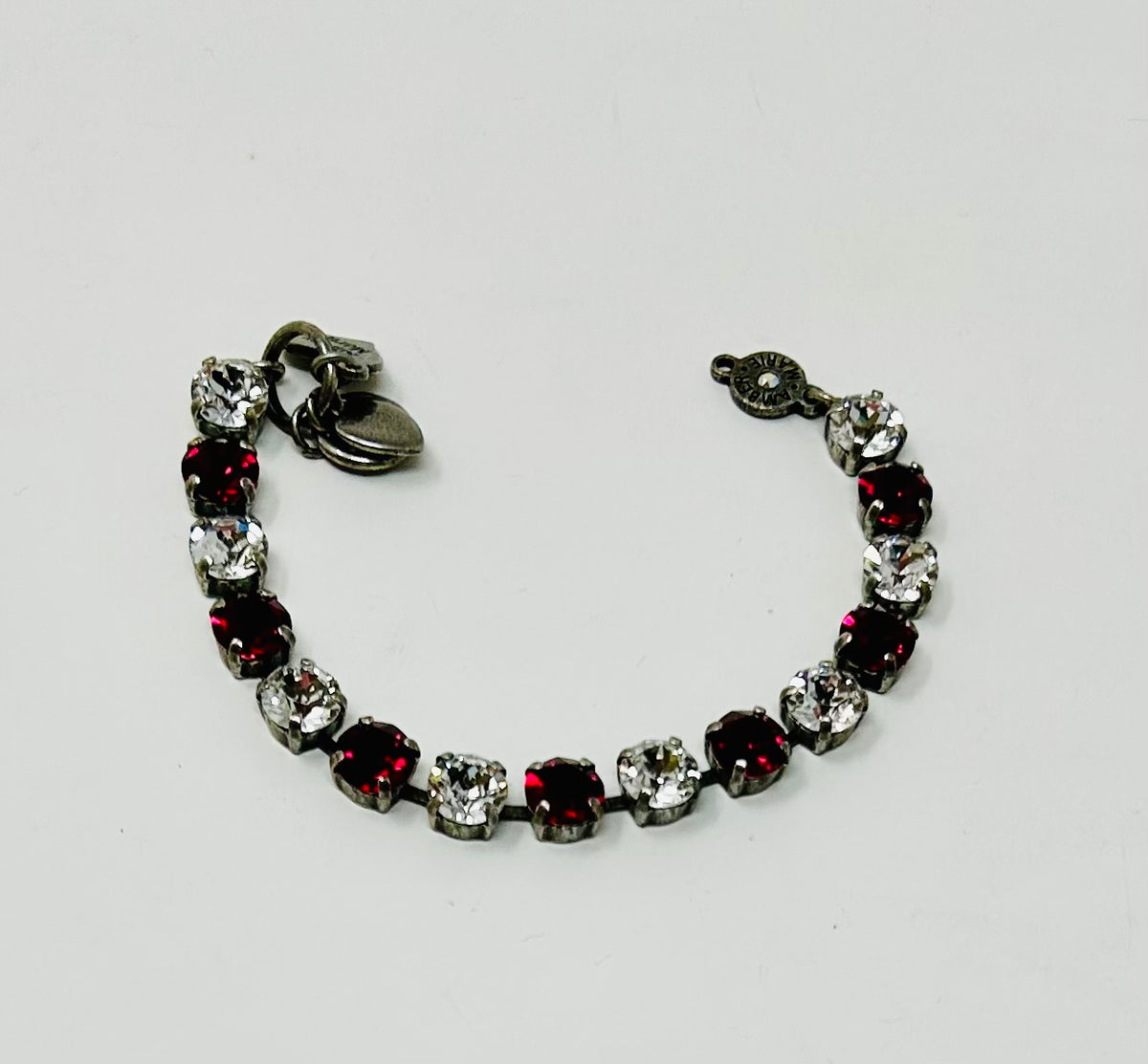 Classic Rome bracelet featuring deep red, black, and clear stones in a sleek silhouette.