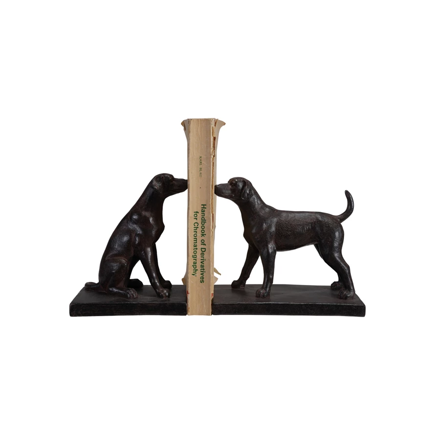 Set of two black resin dog bookends featuring one sitting and one standing dog holding a book.