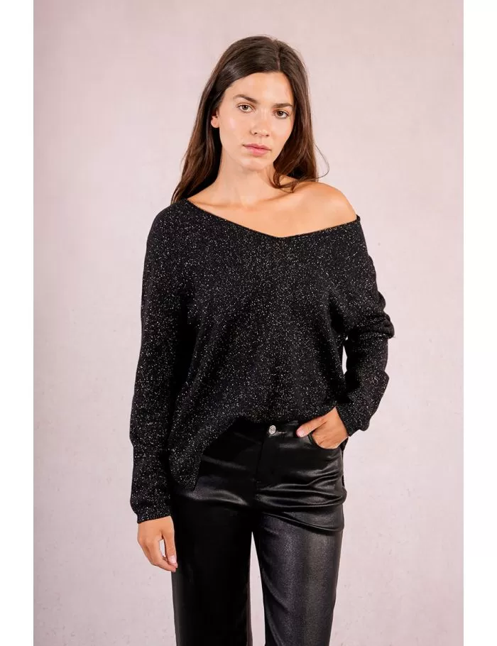 Woman wearing a black Lesli Ladies Knitted Sweater with silver sparkles and black leather pants.