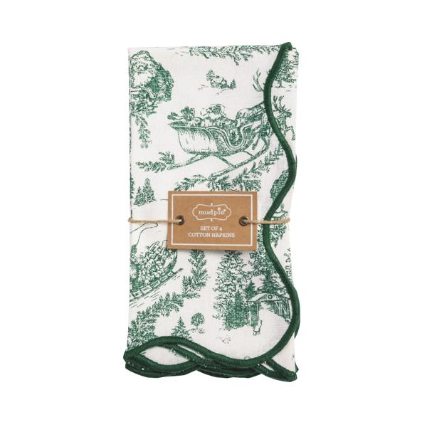 Set of four white cotton dinner napkins with a green toile holiday pattern and scalloped edges.