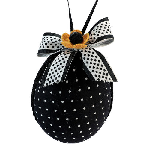 Black egg-shaped ornament with white polka dot pattern
