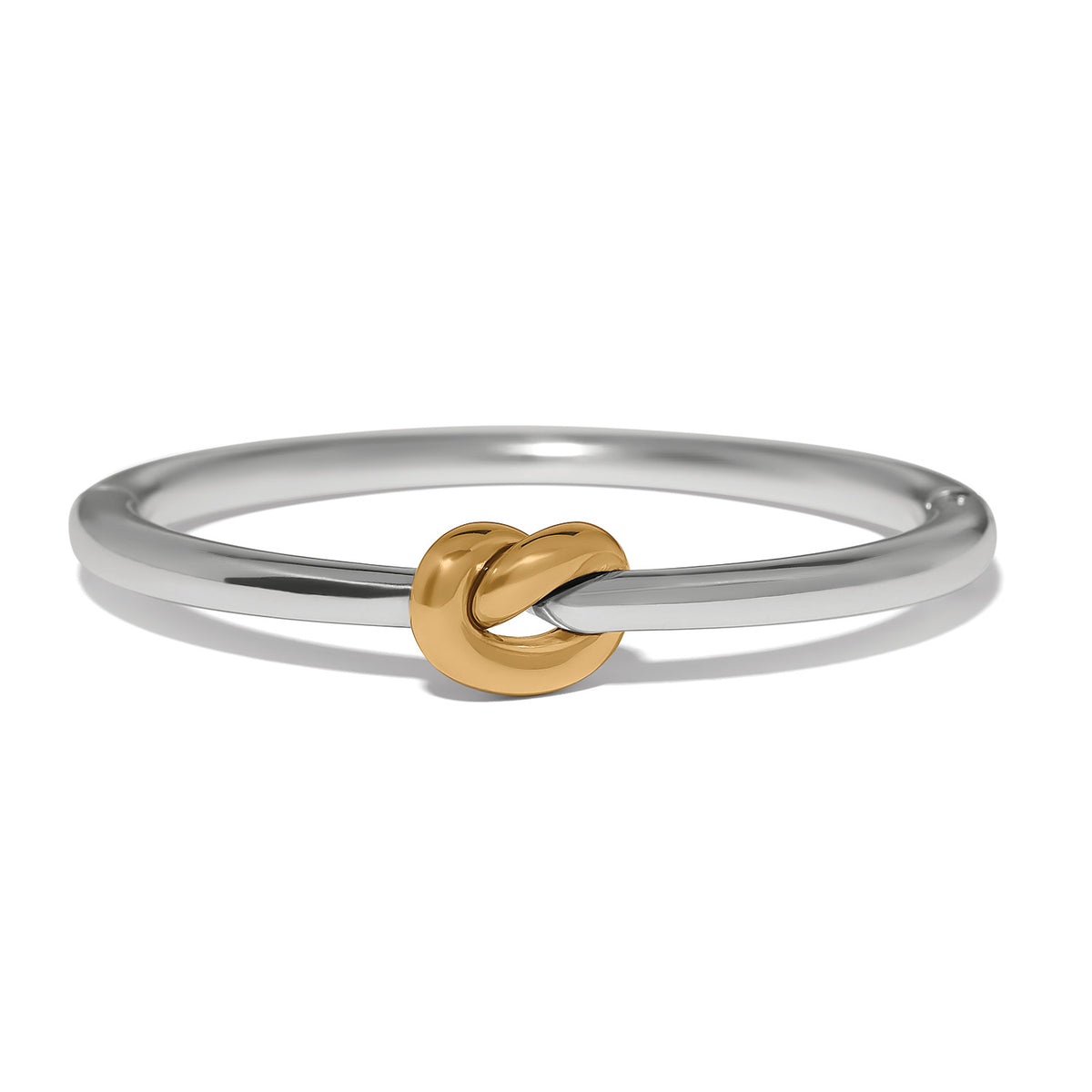 Interlok silver hinged bangle featuring a central gold-tone single knot detail.