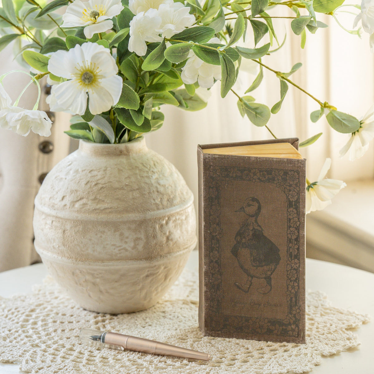 7-inch wooden journal with a dark cover featuring the title Rainy Day Stories.