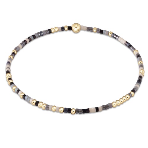 Hope Unwritten bracelet featuring mixed seed beads in various colors with gold accents on elastic cord.