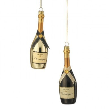 Two glass champagne bottle ornaments, one gold and one black, with festive ribbons and labels.