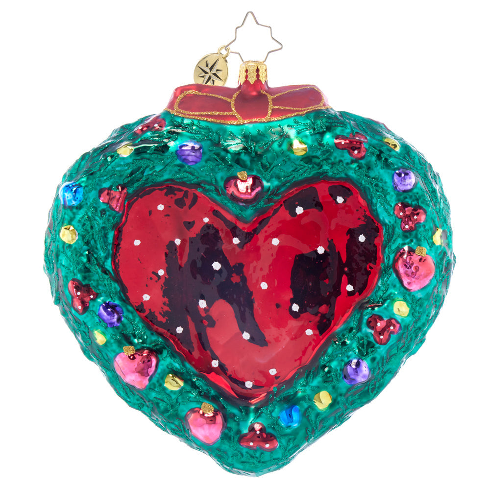Mr. & Mrs. Claus Mistletoe Moment ornament with red and green figures hanging from a mistletoe branch.
