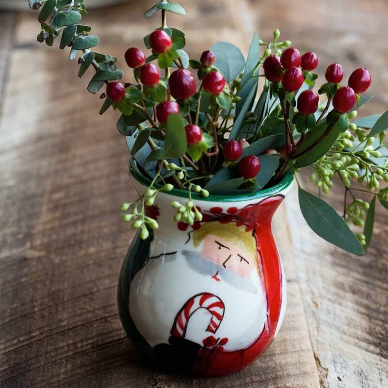 Old St. Nick Bud Vase featuring a hand-painted Santa Claus holding a candy cane with red berries.