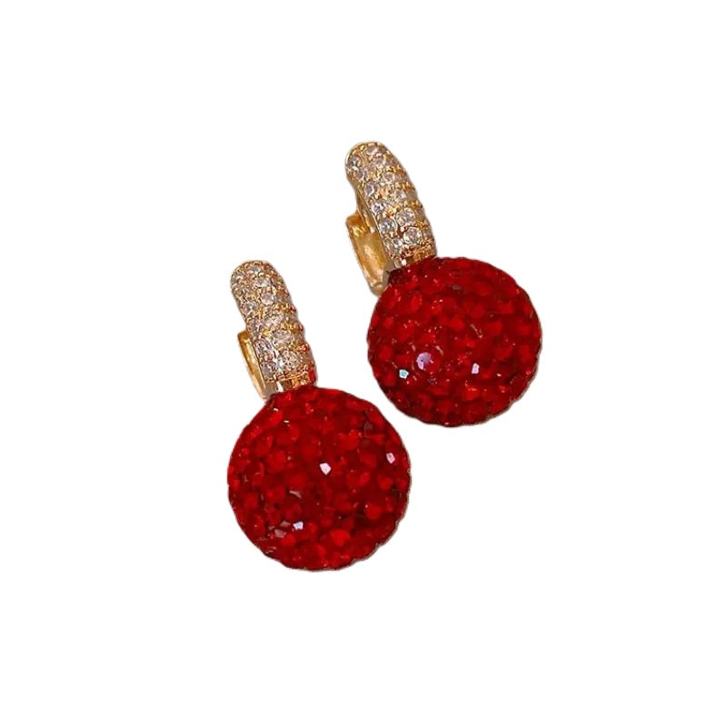 Red sparkle ball earrings with a round silhouette