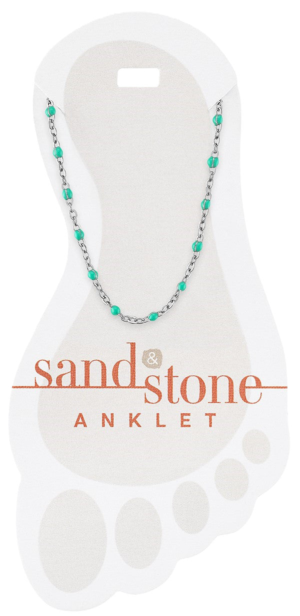 Silver petite anklet with small turquoise blue beads on a delicate chain, displayed on a card.