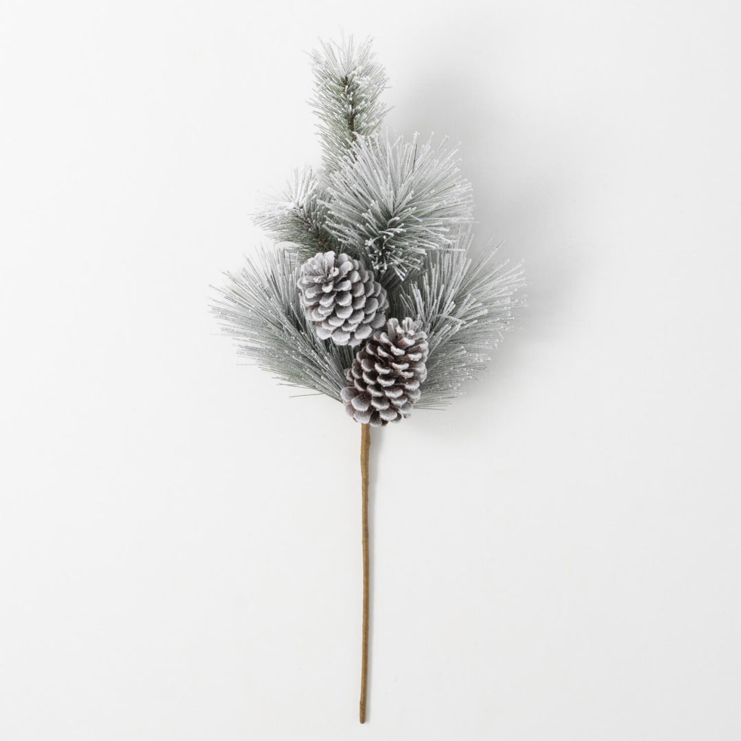 Flocked green pine spray with two snow-dusted pinecones on a long brown stem.