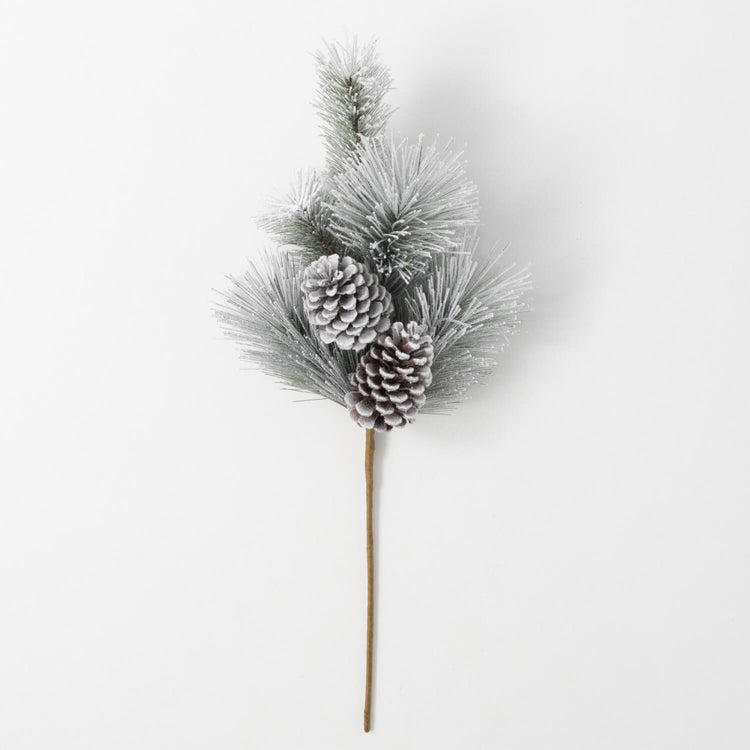 Flocked green pine spray with two snow-dusted pinecones on a long brown stem.