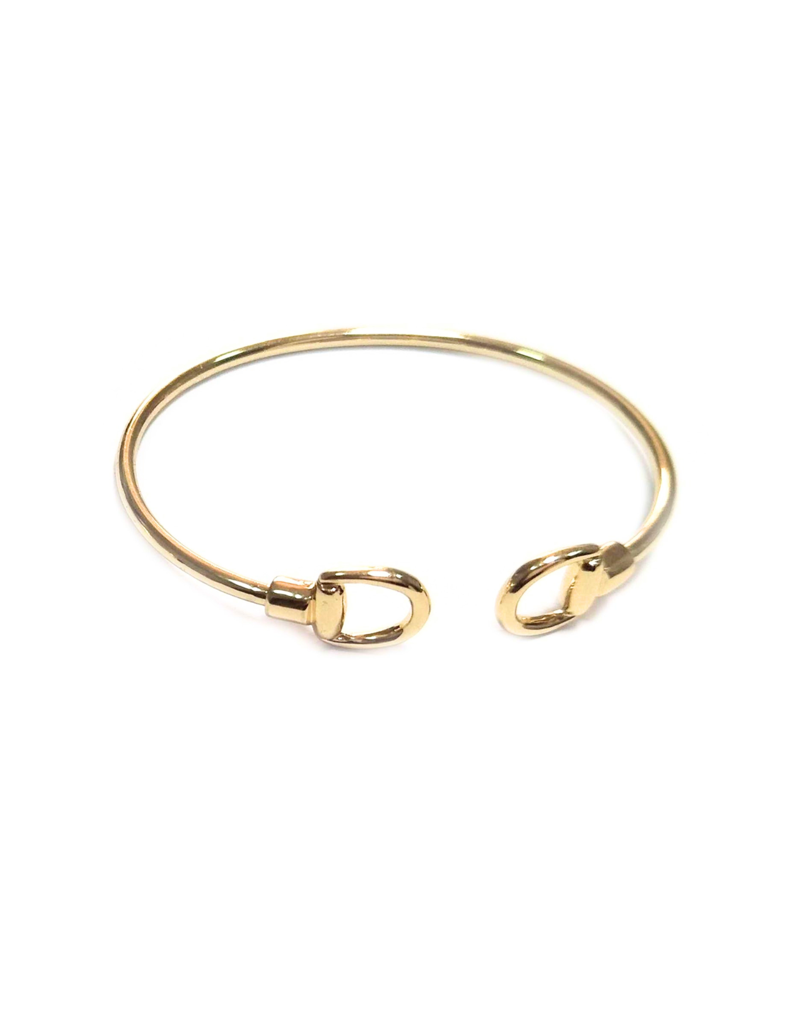 Dainty gold cuff bracelet with polished open-cuff design and lobster claw inspired end accents.