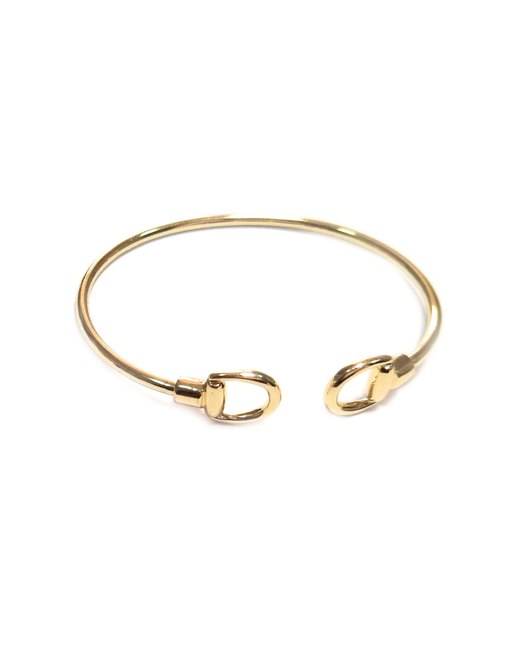 Dainty gold cuff bracelet with polished open-cuff design and lobster claw inspired end accents.
