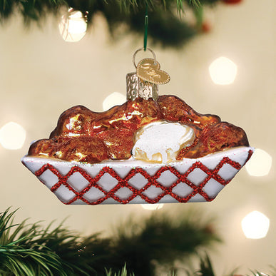 White ceramic ornament shaped like a hot wing with red sauce dip.