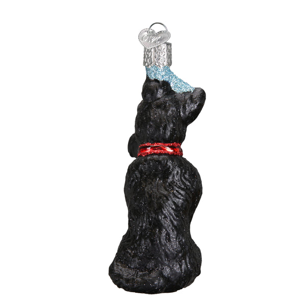 Back view of a black glass Scottish Terrier ornament with a red glitter collar and silver cap.