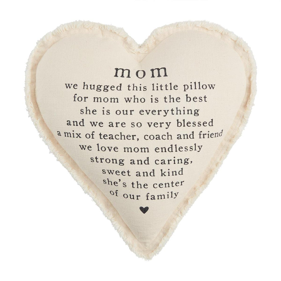 Heart-shaped cream pillow with frayed edges and a sentimental poem printed in black text for Mom.