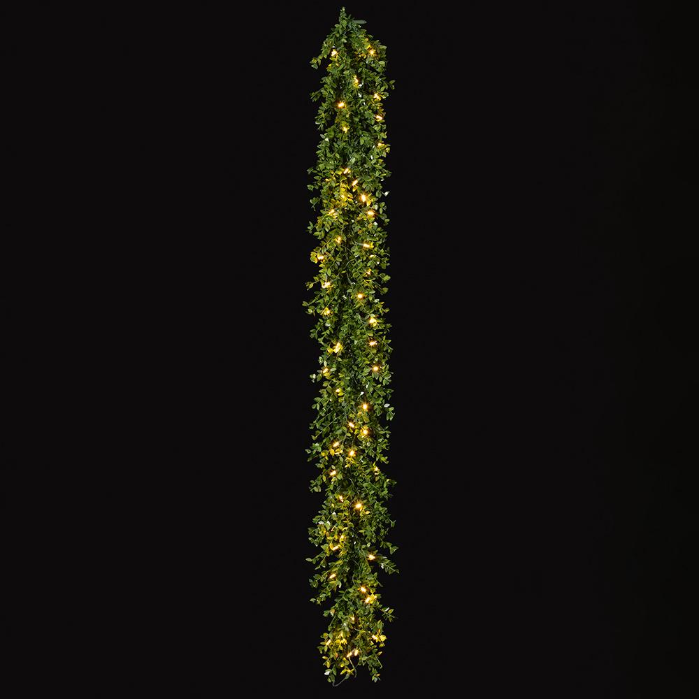 6-foot green mini leaf garland with 50 warm white LED lights against a black background.