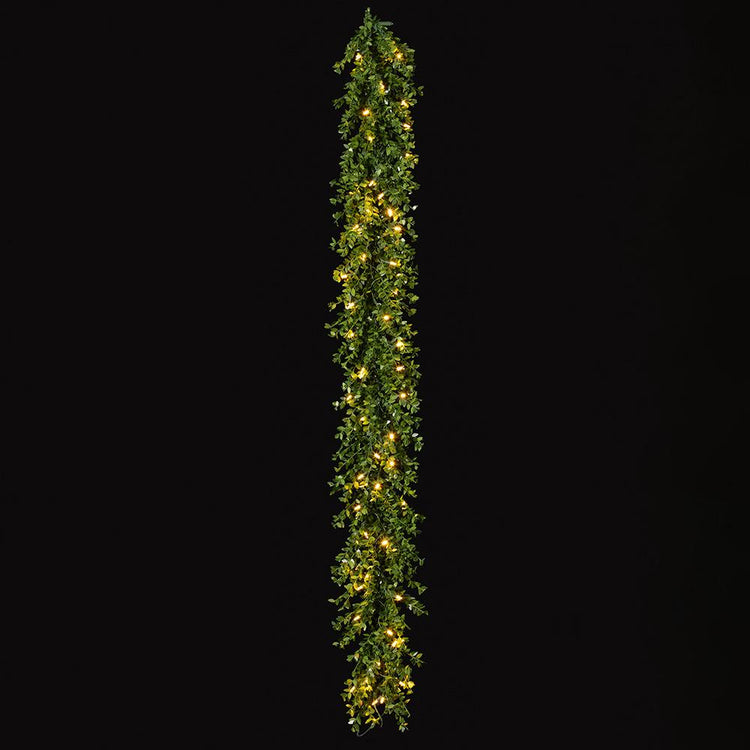 6-foot green mini leaf garland with 50 warm white LED lights against a black background.