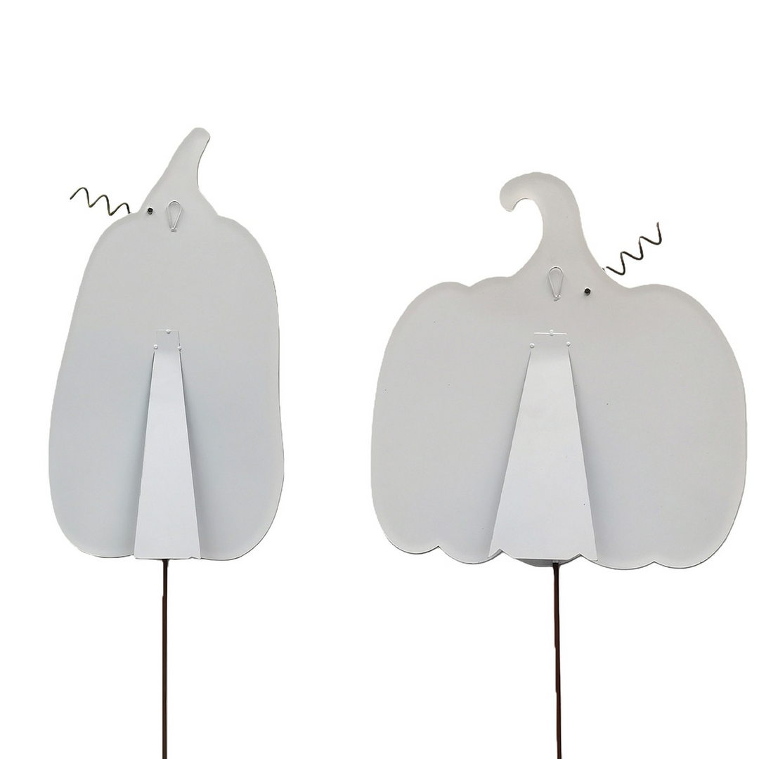 Back view of two white metal pumpkin garden stakes with easel stands and hanging loops.