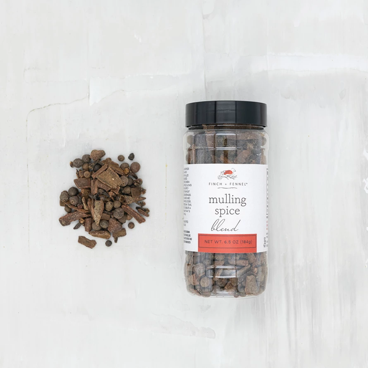 Finch + Fennel Mulling Spice Blend in a 6.5 oz jar next to a pile of whole spices.