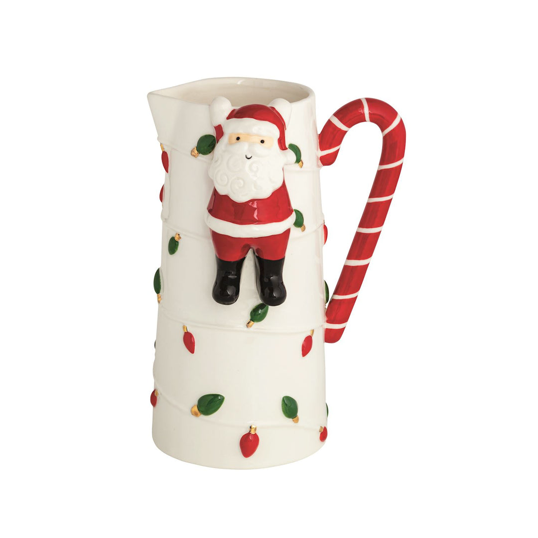 White stoneware pitcher with a hanging Santa figure, candy cane handle, and painted light bulbs.