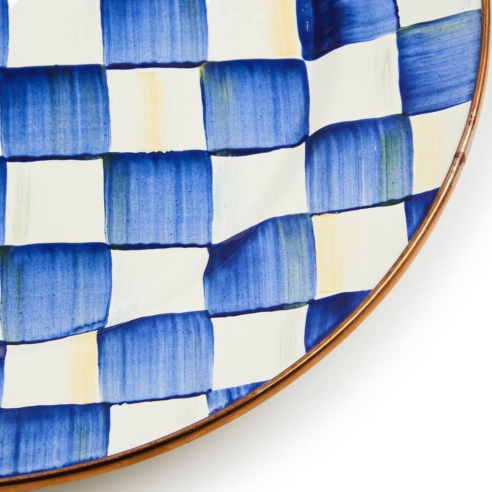 Close-up of a Royal Check Enamel Plate featuring hand-painted blue and white checks and bronze rim.
