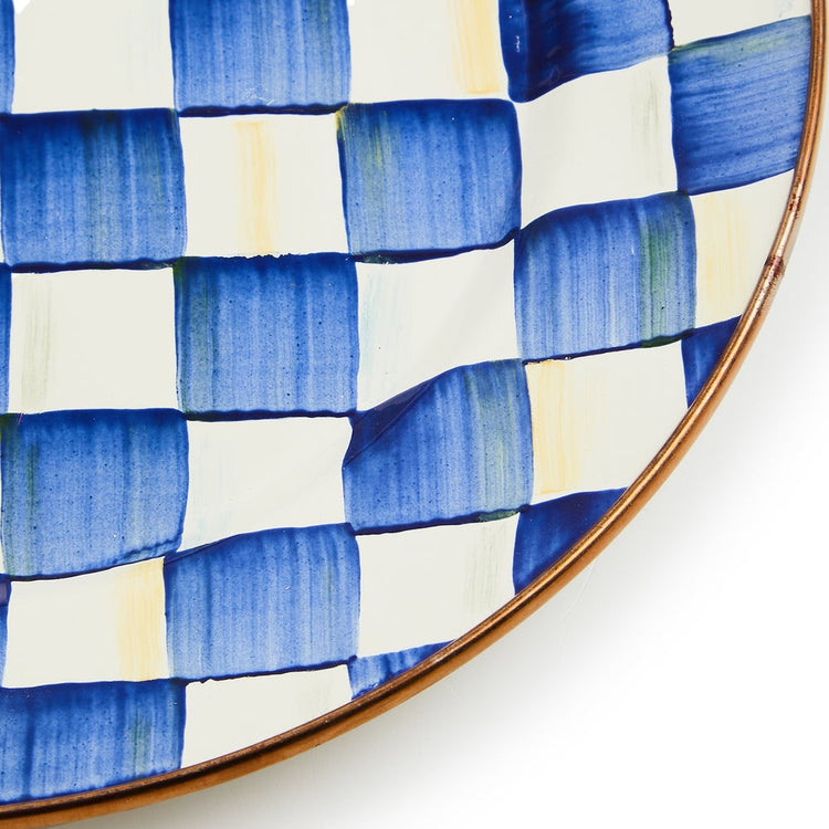 Close-up of a Royal Check Enamel Plate featuring hand-painted blue and white checks and bronze rim.