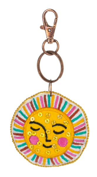 Multi-colored embroidered sun charm with beaded accents on a purse accessory