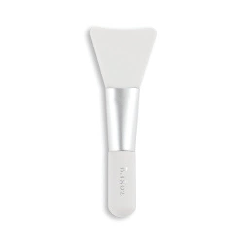 White plastic spatula with a rounded handle designed to scoop whipped body cream from jars.