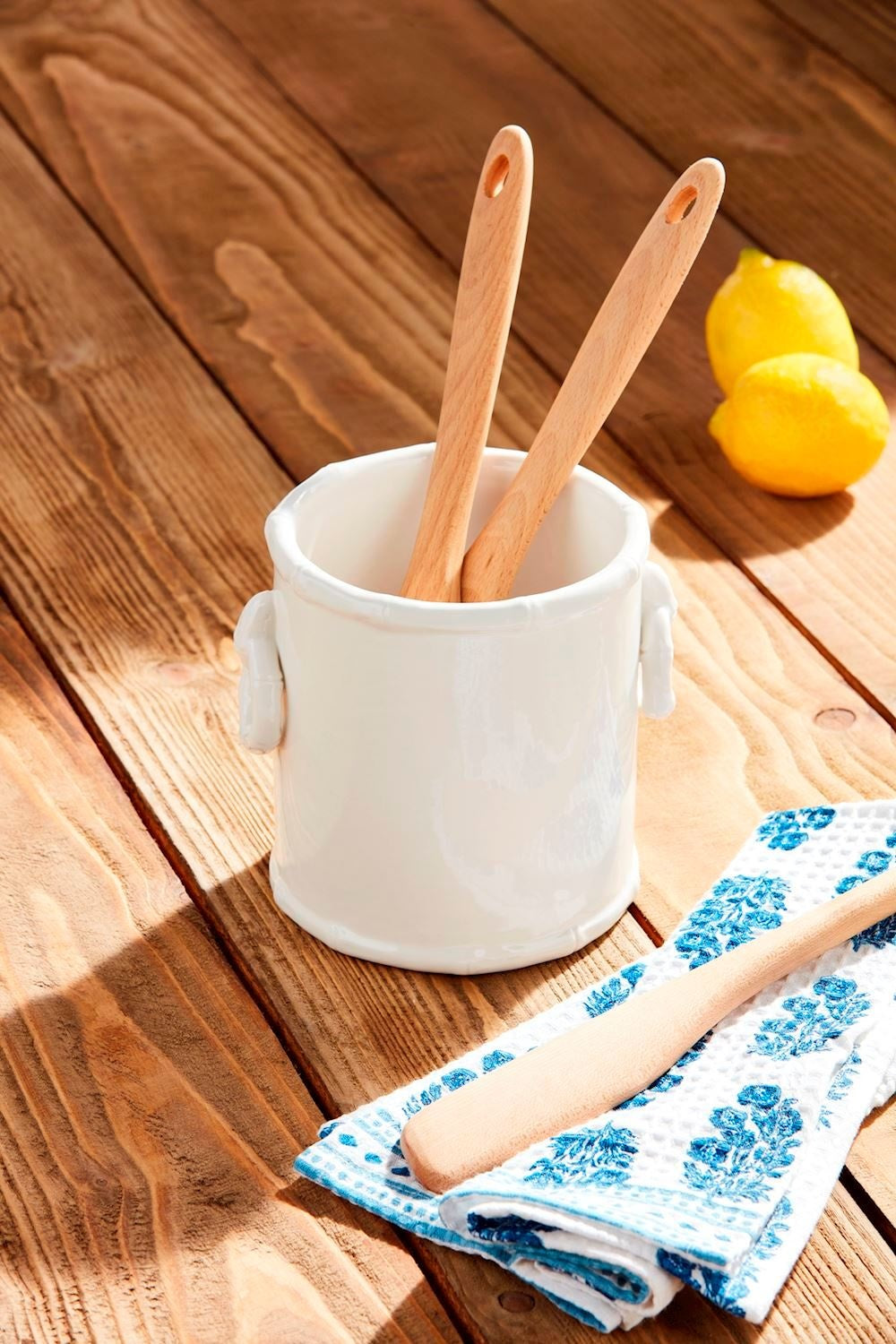 White stoneware utensil holder with bamboo textured detail and side ring handles.