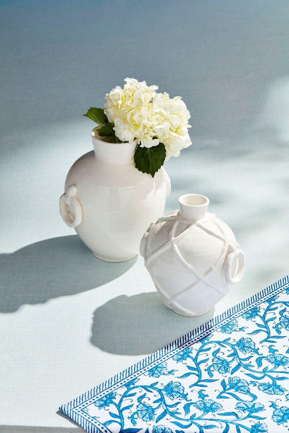 White stoneware vase with bamboo textural detail and side ring handles.