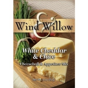 White cheddar cheeseball mix with green chive specks in a clear container