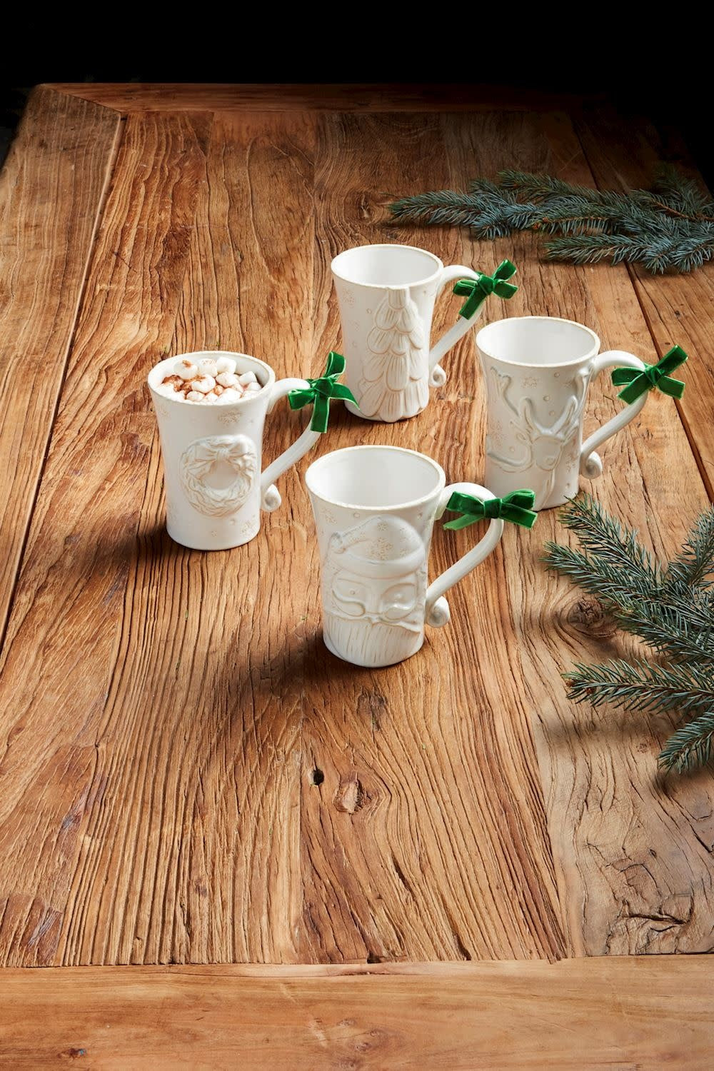 White Christmas stoneware mug with milk glaze texture and raised antique wash motif.