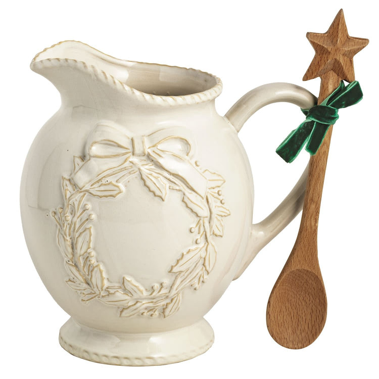 White milk glazed stoneware Christmas pitcher with textured relief and wooden star spoon