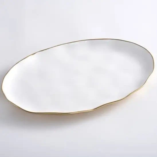 White oval high-fired porcelain tray with gold titanium accents.