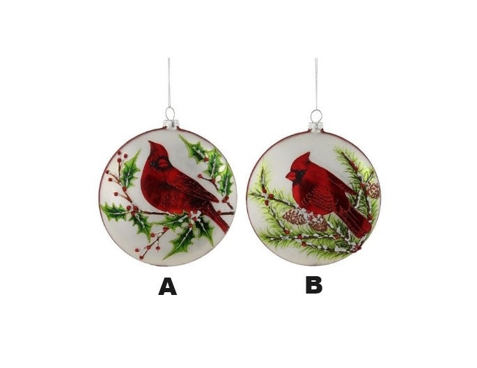 White glass disc ornament with red cardinal silhouette on green background