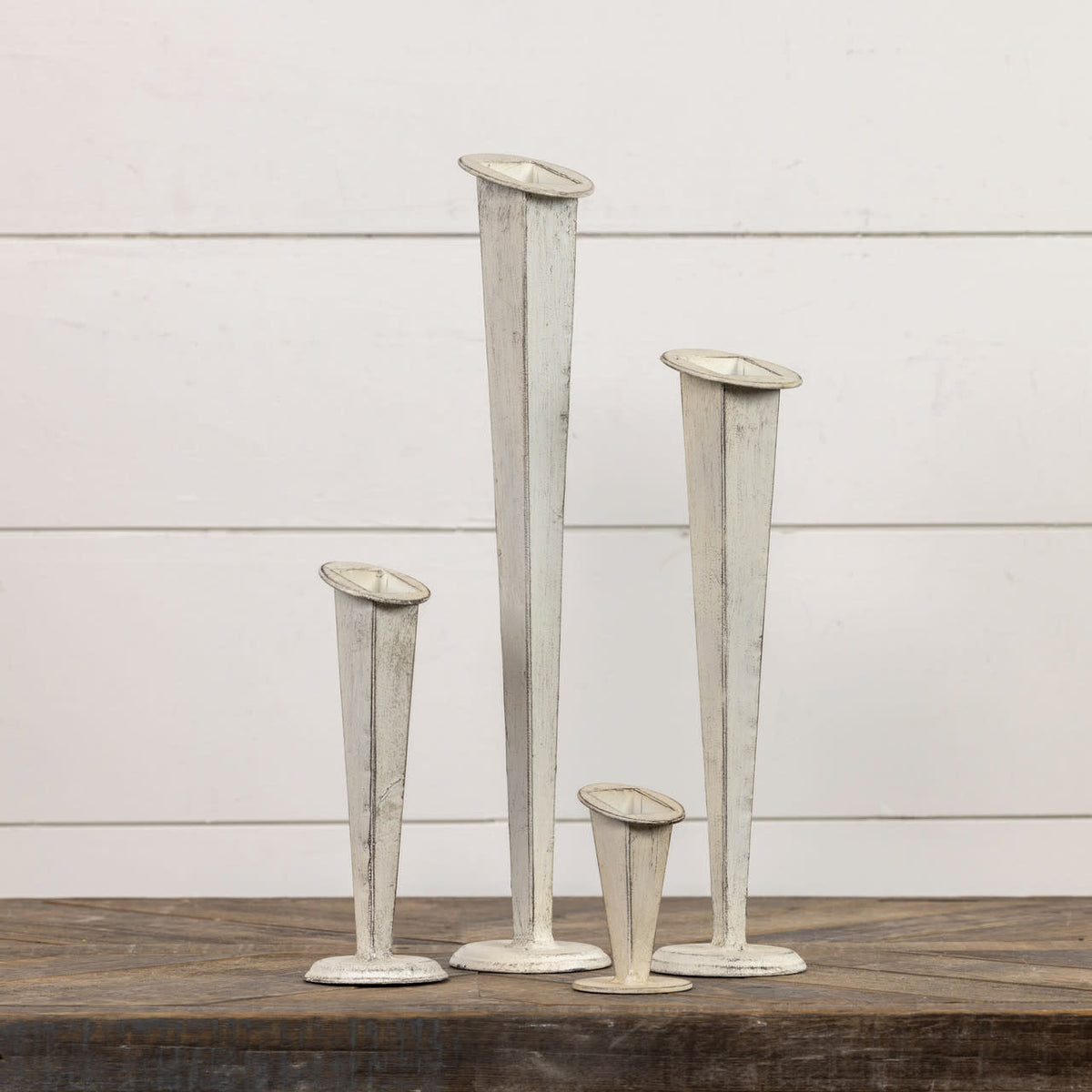 White tapered metal vase with a sleek conical silhouette.