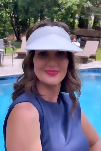 White women's open-top sun visor hat with wide brim and elasticized chinlon fabric.