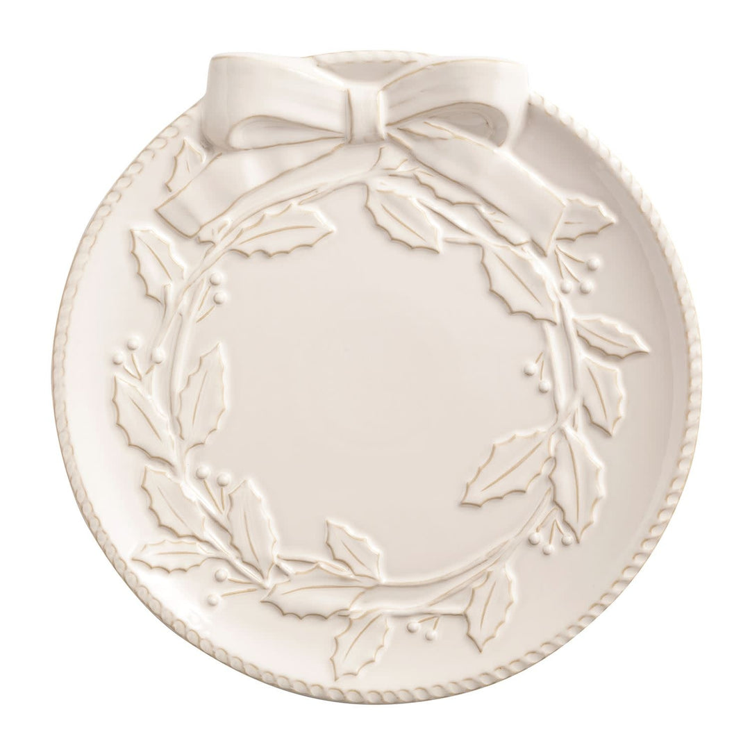 White milk glazed stoneware platter with textured relief and wooden serving tongs.
