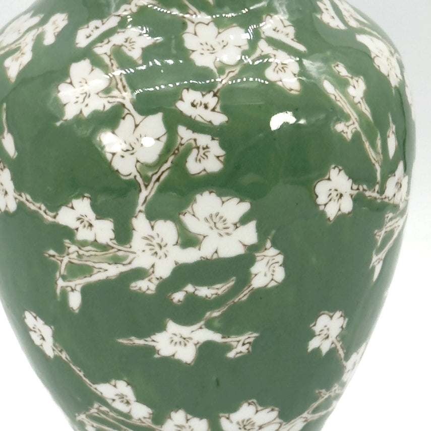 Green ceramic vase with white sakura floral chinoiserie pattern