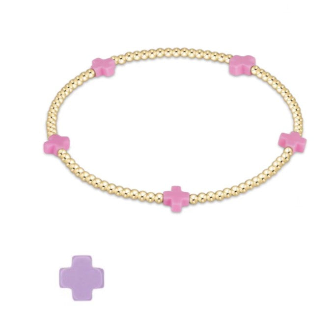 Purple elastic bracelet with small gold-filled beads featuring a cross pattern.