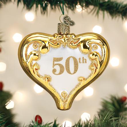 Heart-shaped 50th Anniversary glass ornament with gold glitter accents hanging on a Christmas tree.